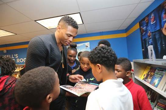 Russell shares a book with the children