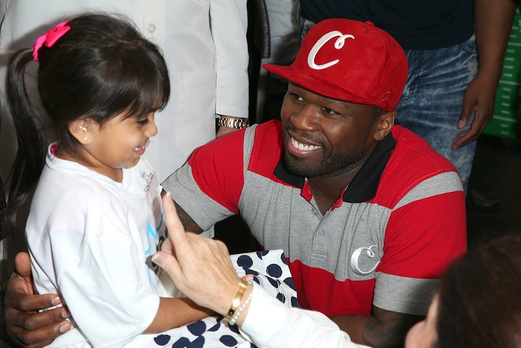 50 Cent attends to patient Isabella at the Starkey Hearing Foundation hearing mission during Super Bowl weekend 2016