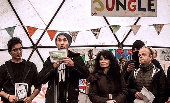 Barbak (a refugee), Jude Law, Shappi Khorsandi and Toby Jones at the Good Chance theatre in the Calais Camp Barbak (a refugee), Jude Law, Shappi Khorsandi and Toby Jones at the Good Chance theatre in the Calais Camp