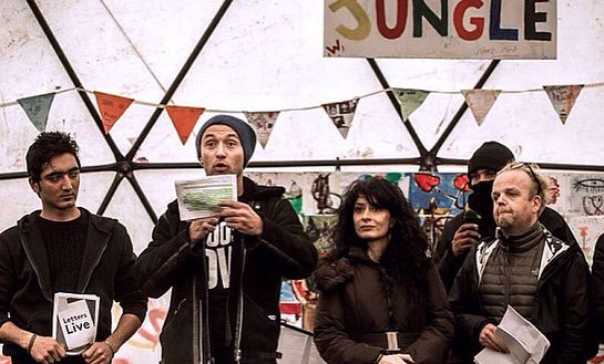 Barbak (a refugee), Jude Law, Shappi Khorsandi and Toby Jones at the Good Chance theatre in the Calais Camp