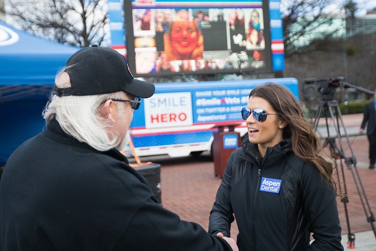 Air Force veteran Randall Murray, left, talks with Danica Patrick at the Aspen Dental MouthMobile as part of the Healthy Mouth Movement 2016 launch