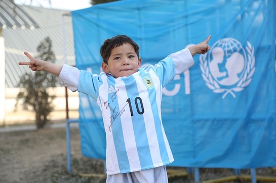 Murtaza proudly shows off his new signed jerseys and a football he received from UNICEF Goodwill Ambassador Leo Messi