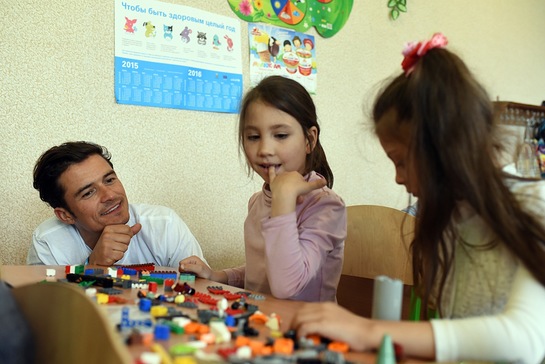 Orlando Bloom plays lego with pupils of School #13 in Slovyansk, as part of a visit to conflict-hit eastern Ukraine.