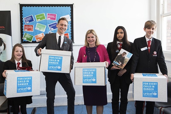 Tom Hiddleston with the Secretary of State for International Development Justine Greening and pupils from Hampstead School, London.