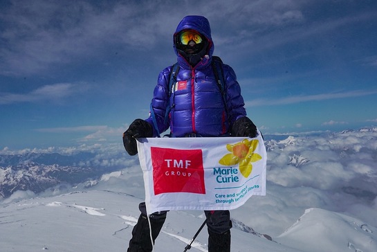 TMF Group brand ambassador Sir Ranulph Fiennes holds Marie Curie banner at the top of Mount Elbrus