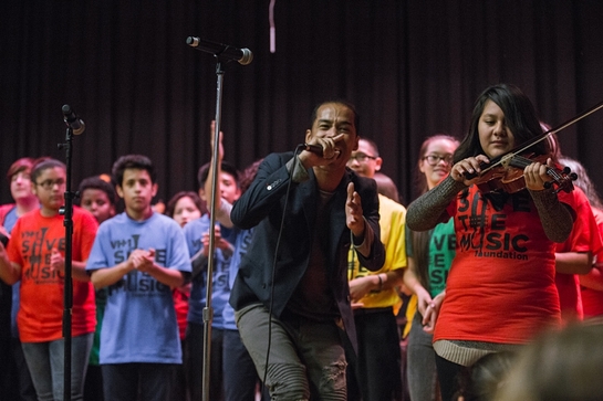 Sir the Baptist performing with students at John Spry Community School as part of Toyota Giving and VH1 Save the Music's grant presentation