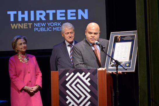 Maya Angelou's grandson Colin Johnson presents Secretary Hillary Clinton and President Bill Clinton with a plaque of her inauguration poem