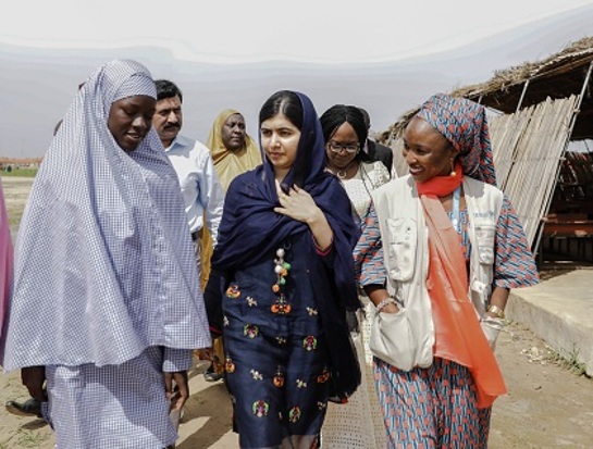 Malala Yousafzai is shown around the school in Bakassi camp by student, Fatima Grema Malala Yousafzai is shown around the school in Bakassi camp by student, Fatima Grema