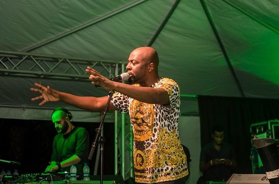 Wyclef Jean performing on stage at Jumby Bay in Antigua