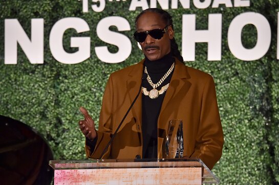 Snoop Dogg accepts an award onstage during City of Hope: 15th Annual Songs of Hope Snoop Dogg accepts an award onstage during City of Hope: 15th Annual Songs of Hope