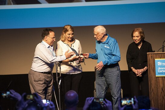 Jimmy Carter and former First Lady Rosalynn Carter passing a ceremonial trowel to Cesarina Fabian and Celso Marranzini