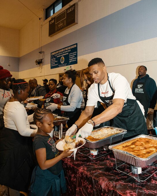  Russell Westbrook serving Thanksgiving dinners.