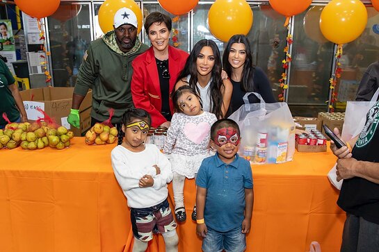 Kris Jenner, Kim Kardashian West, Kourtney Kardashian and Corey Gamble help out the Los Angeles Regional Food Bank.