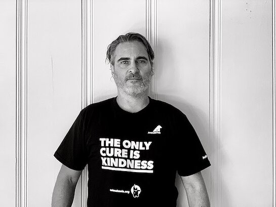 Joaquin Phoenix wearing a t-shirt bearing the words 