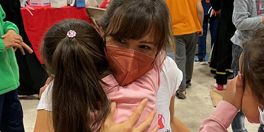 Jennifer Garner receives a hug from a girl at a temporary shelter for Afghan children