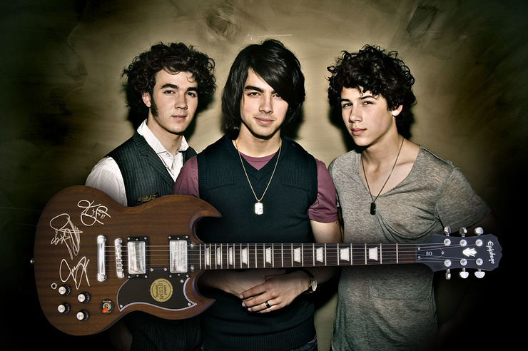 Jonas Brothers with auctioned Epiphone guitar