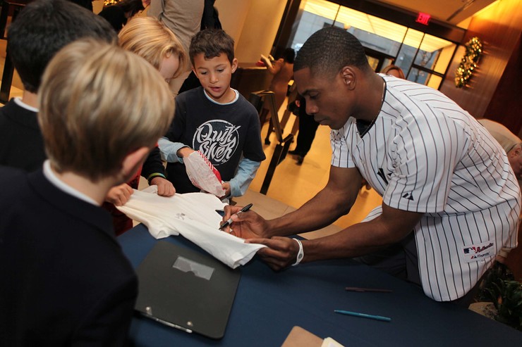 Curtis Granderson signs photos and chats with his young fans.
