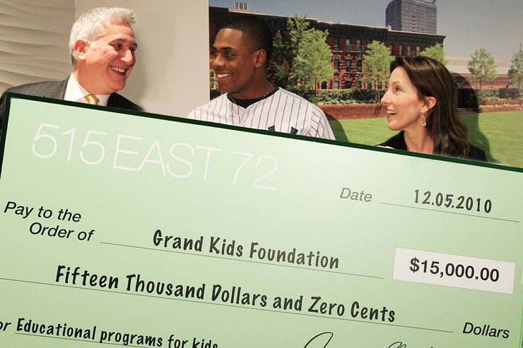 The 515 East 72nd Street team presents Curtis Granderson with the home run charity campaign check.