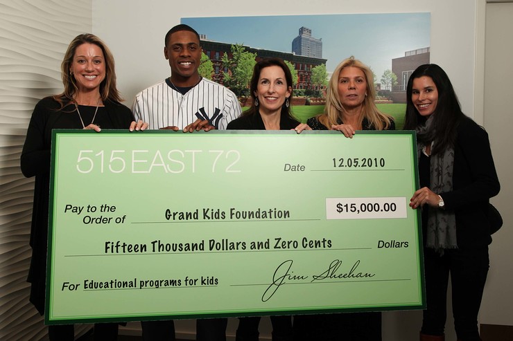 The 515 East 72nd Street sales team gathers with Curtis Granderson after the home run charity campaign check presentation.