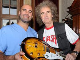 Brian May and Marc Abrahams sign PUP AID Guitar Brian May and Marc Abrahams sign PUP AID Guitar