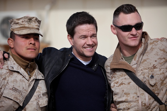 Marines with 1st Marine Logistics Group (Forward) take a photo with actor Mark Wahlberg during Wahlberg's visit of 1st Marine Logistics Group (Forward) at Camp Leatherneck, Afghanistan, Dec. 19.
