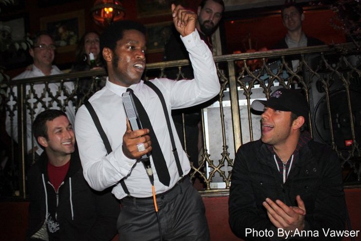 Zachary Levi (right) claps to the performance of Vintage Trouble