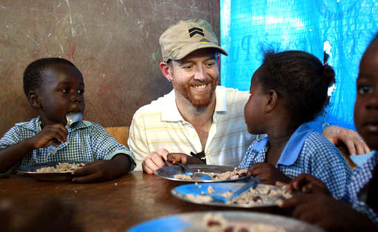 Dave "Phoenix" Farrell joins first graders at a school in Port au Prince