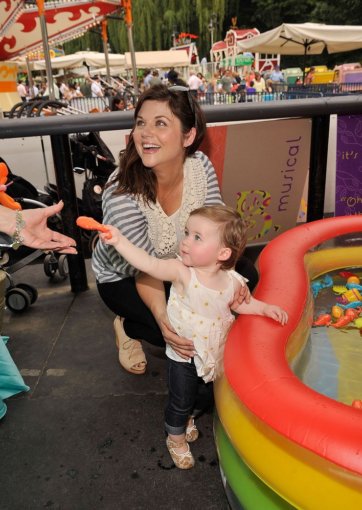 Baby Buggy supporter Tiffani Thiessen playing in the pool with her daughter Harper at the Baby Buggy Bedtime Bash