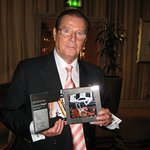 Roger Moore Signs Toy James Bond Cars For Celebrity Charity Auction