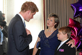 Prince Harry meets Adam Beckett(12), winner of the Most Caring Child Award, with mum Trina - Wednesday 31st of August 2011. .