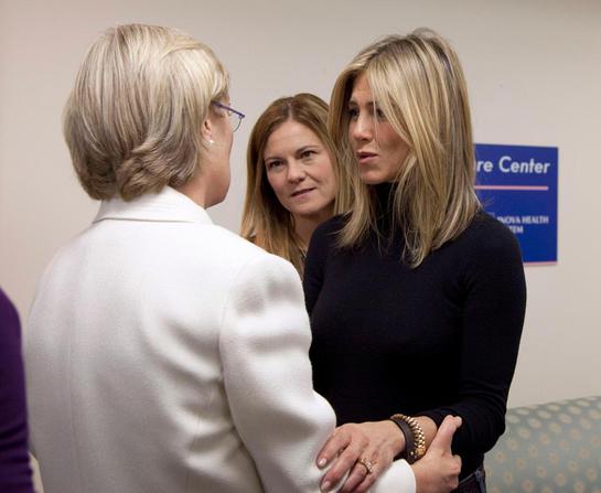 Producer Kristin Hahn, center, and actress and producer Jennifer Aniston, talk with a breast cancer survivor at the Inova Breast Care Center (AP Photo/Carolyn Kaster)