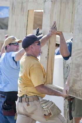 Garth Brooks helps move a wall into place during Habitat for Humanity's 2011 Jimmy & Rosalynn Carter Work Project in the Santo community in Haiti. 