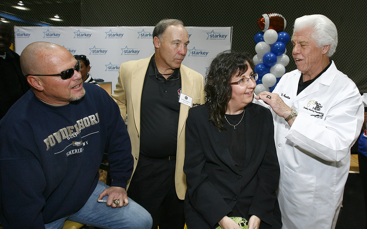 Joe DeLamielleure and Jim McMahon Help Bill Austin Provide Catherine Donaldson With Hearing Aids