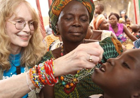 Mia gives a boy a dose of oral polio vaccine at an immunisation site in Moundou, Chad