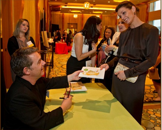 Peter H. Reynolds autographs a book for event special guest Bridget Moynahan.