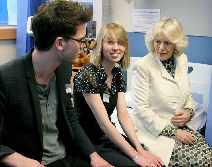 HRH The Duchess of Cornwall speaking with Jeremy Irvine, star of recent Hollywood blockbuster ‘War Horse’ and Hannah Day at the Addenbrooke visit