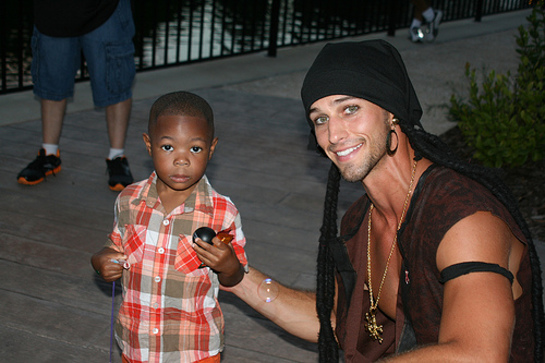 Survivor One World contestant Jay Byars gives a hug to a GKTW wish child.