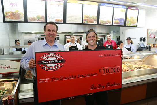 Boston Market CEO George Michel (A.K.A. The Big Chicken) presents a $10,000 check to pro skateboarder Ryan Sheckler at Boston Market