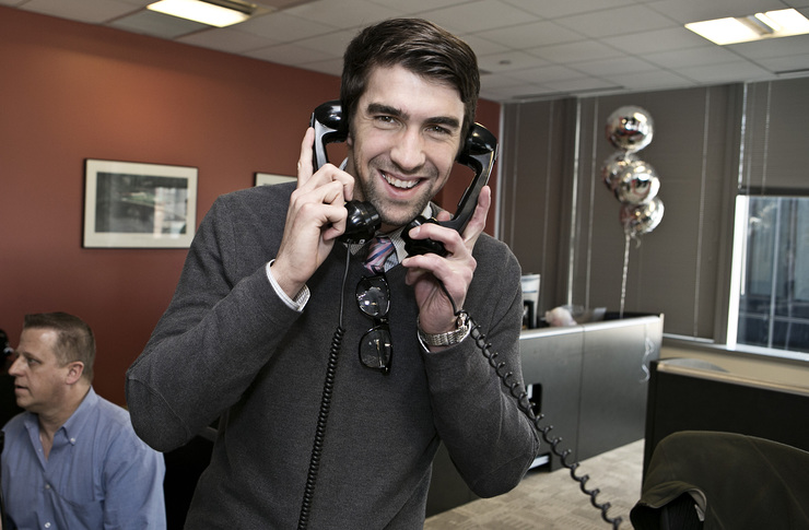 Olympic Gold Medalist Michael Phelps answers the phones on the trading floor at ICAP’s North American headquarters.