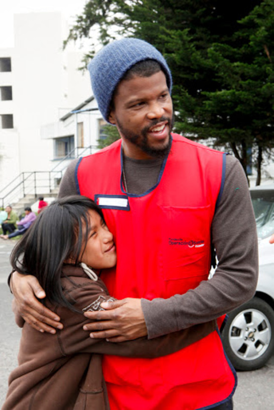 Smile Ambassador, Sharif Atkins, jokes around with a child during the screening process at Operation Smile Surgical mission in Quito, Ecuador on Wednesday, January 23, 2013.