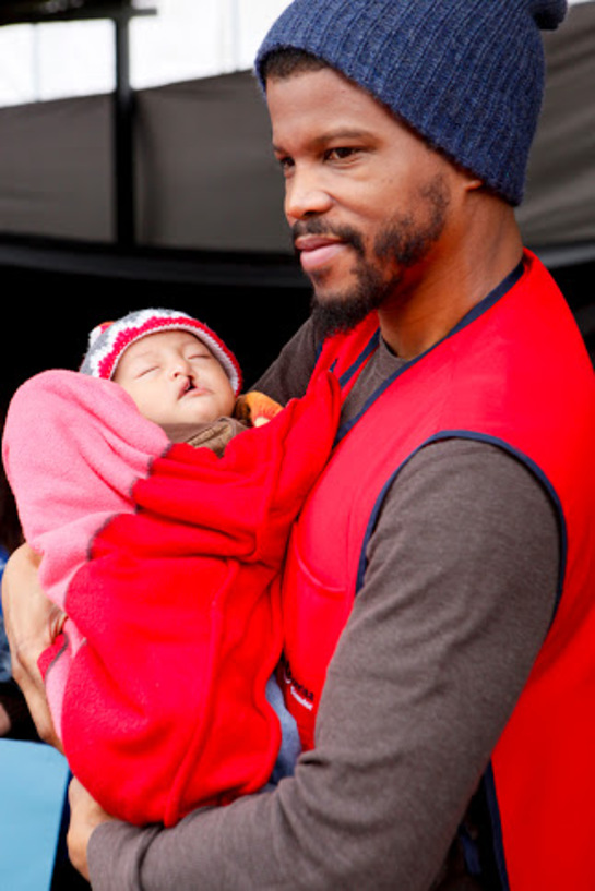 Sharif Atkins, with 4 month old cleft lip patient, Michael Andres Cevollos during the screening process at Operation Smile Surgical mission in Quito, Ecuador