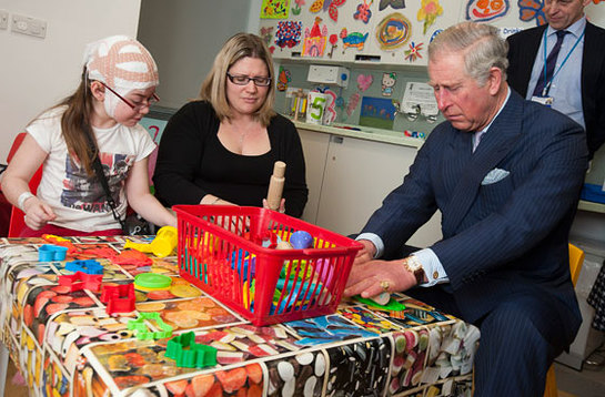 The Prince of Wales rolls out Play-Doh with eight-year-old Katie Tuffin and her mother Emma 