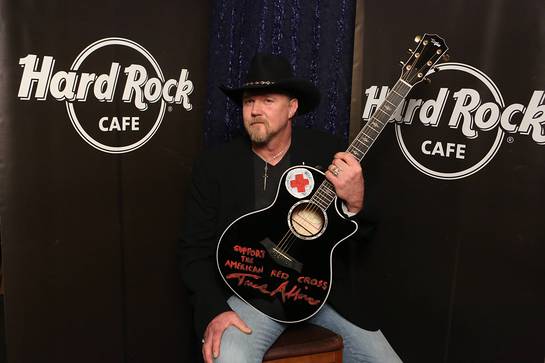 Trace Adkins, donates his hand-painted black Taylor guitar with the globally recognized symbol of the American Red Cross to Hard Rock's world famous memorabilia collection as part of the most recent challenge on NBC's All-Star Celebrity Apprentice