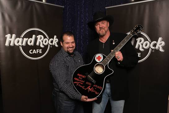 Trace Adkins appears with Hard Rock representative, John Pasquale, as he donates his hand-painted guitar to Hard Rock's world famous memorabilia collection as part of the most recent challenge on NBC's All-Star Celebrity Apprentice,