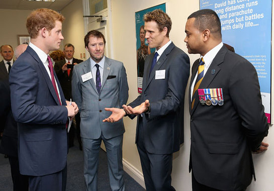 Prince Harry talks to James Cracknell and Johnson Beharry as he opens the new headquarters of Headway, the brain injury charity