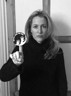 Hollywood star Gillian Anderson brandishes the awáIcon which sends the urgent message, 'Brazil: Save the Awá'.