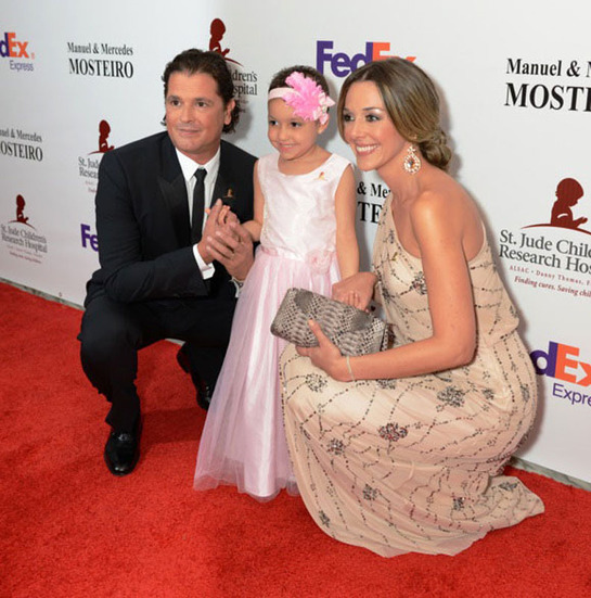 Carlos Vives and wife next to St. Jude patient Izarah at Miami Gala.