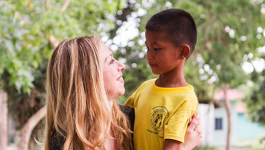 While visiting Clinton Health Access Initiative projects in Cambodia, Chelsea Clinton meets Basil, who was one of the first children to receive pediatric antiretroviral treatment in the country.