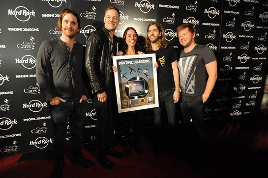 Imagine Dragons band members, left to right, Daniel Platzman, Dan Reynolds, Wayne Sermon and Ben Mckee are presented the RIAA Gold & Platinum career award by RIAA's Liz Kennedy