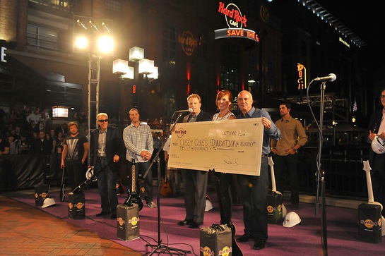 Fred Thimm, Vice President of Hard Rock International, Casey Baynes, Founder of the Casey Cares Foundation, and Hamish Dodds, President and CEO of Hard Rock International present a $10,000 donation to The Casey Cares Foundation